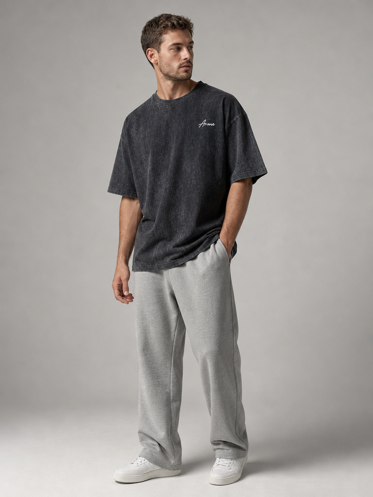 Model wearing the ARME oversized performance tee in washed charcoal, front view