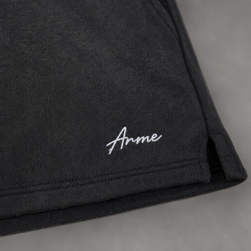 Close-up of ARME embroidery and charcoal French terry fabric