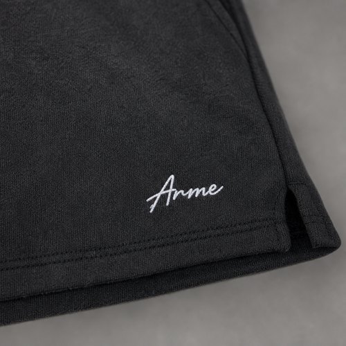 Close-up of ARME embroidery and charcoal French terry fabric